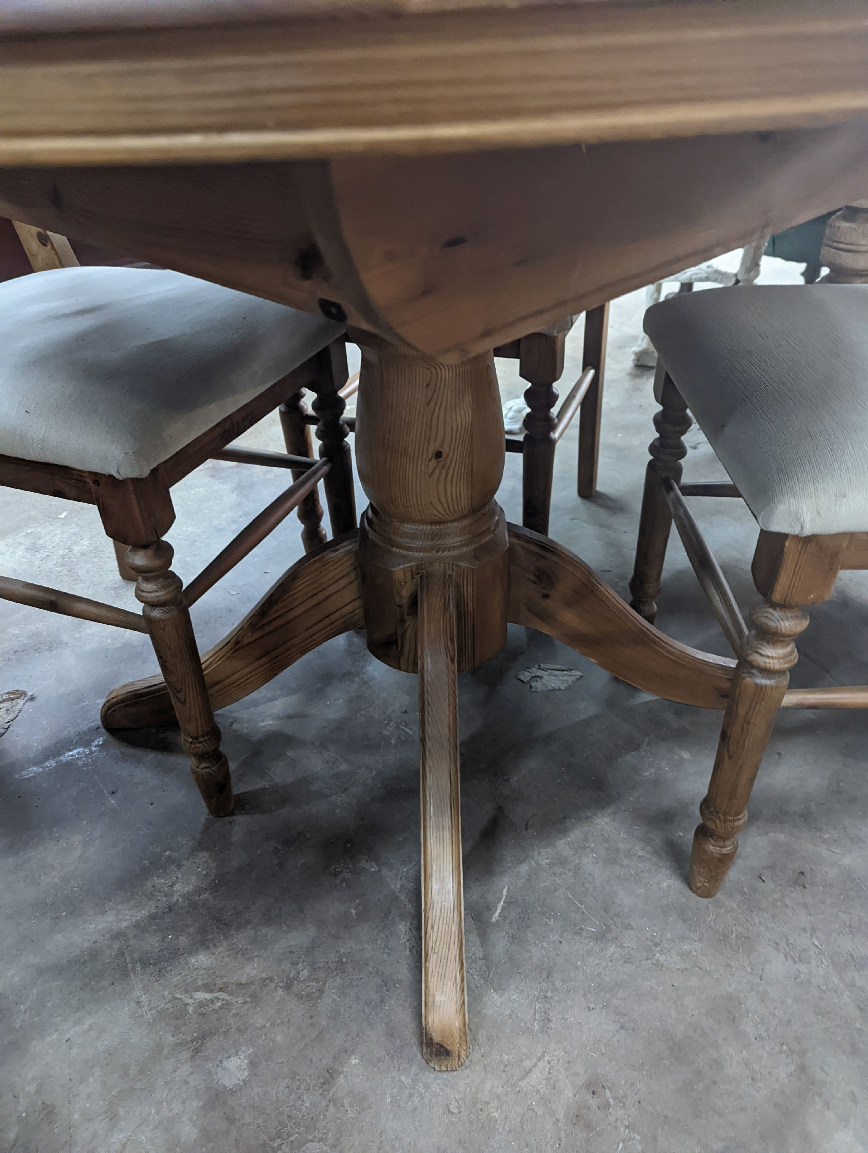 A reproduction circular pine breakfast table, diameter 105cm, height 77cm together with five pine dining chairs